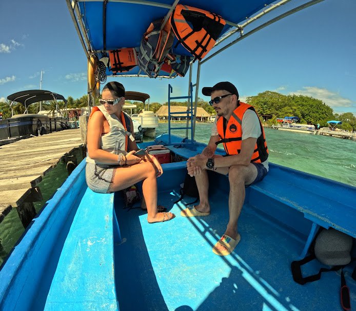 A couple on a private boat exploring Bacalar's serene waters.